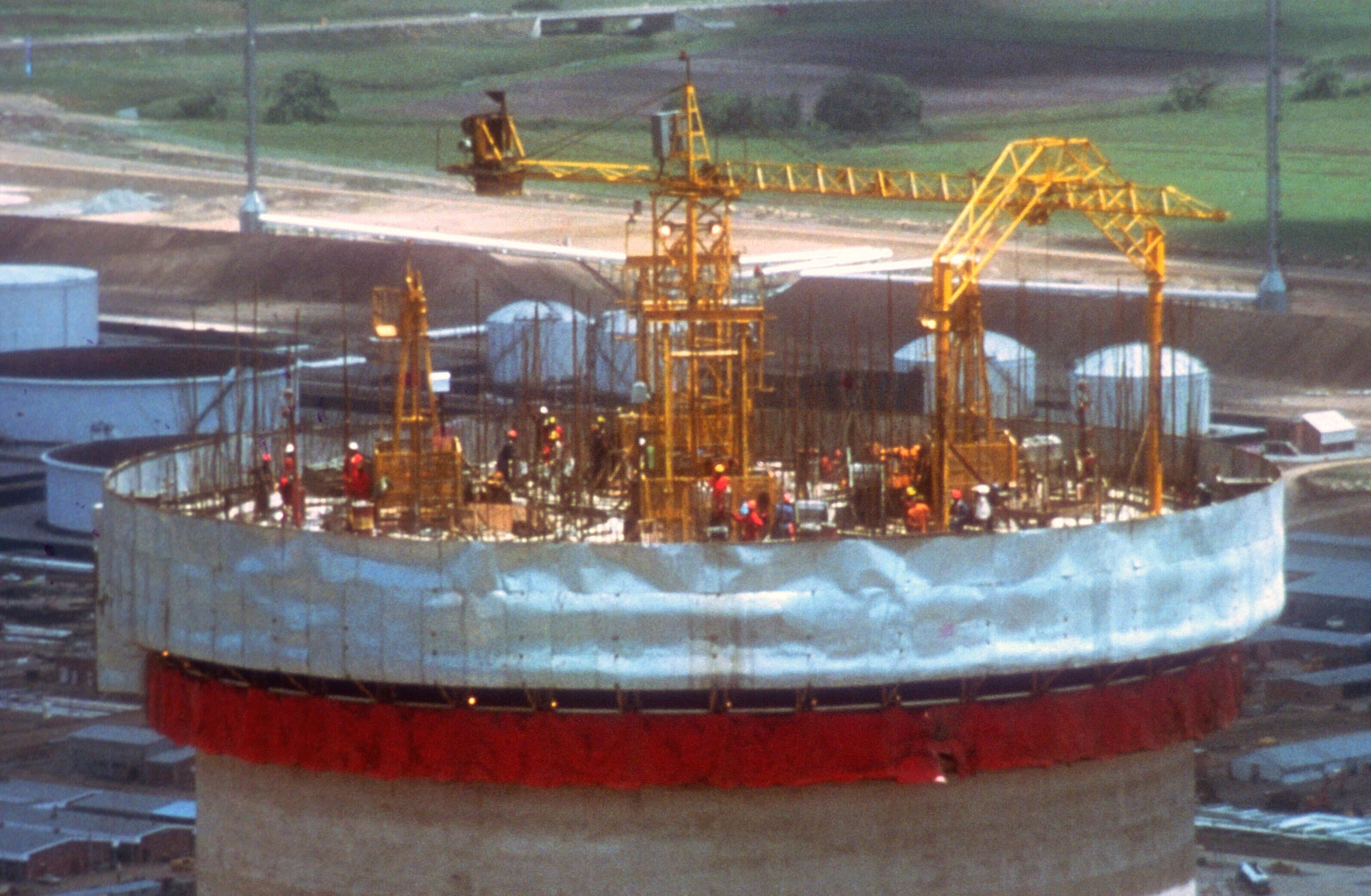 Workers atop cooling tower
